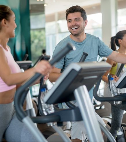Group of people using cardio machines and ellipticals at Everyone Fitness gym